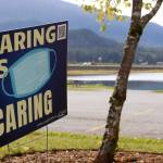 A sign seen near Twin Lakes on Sept. 17, 2020 encourages residents to wear masks in public settings. With cases surging locally, statewide and nationally, City and Borough of Juneau announced it would be fully implementing mitigation measures. (Ben Hohenstatt / Juneau Empire File)