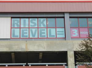 The windows of the downtown branch of the Juneau Public Library tell passers-by that the city's overall COVID-19 alert level is high on August 20. City officials raised the alert level to curb the spread of the delta variant of COVID-19, which has been spreading rapidly throughout Alaska, including Juneau. All three Juneau Public Libraries will have reduced hours starting Monday, August 23, as staff are reassigned to help with the pandemic response, city officials said in a news release late Friday. (Dana Zigmund/Juneau Empire)