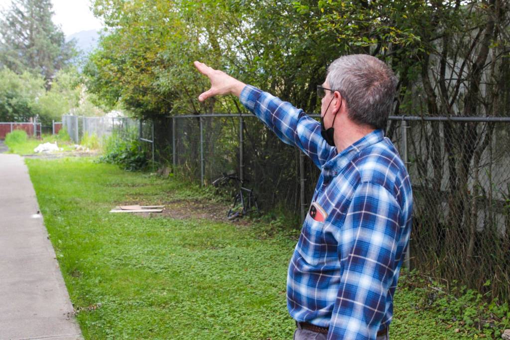 Dave Ringle, general manager of St. Vincent de Paul Juneau, gestures at building siding that was recently replaced on Aug. 20, 2021. (Michael S. Lockett / Juneau Empire)