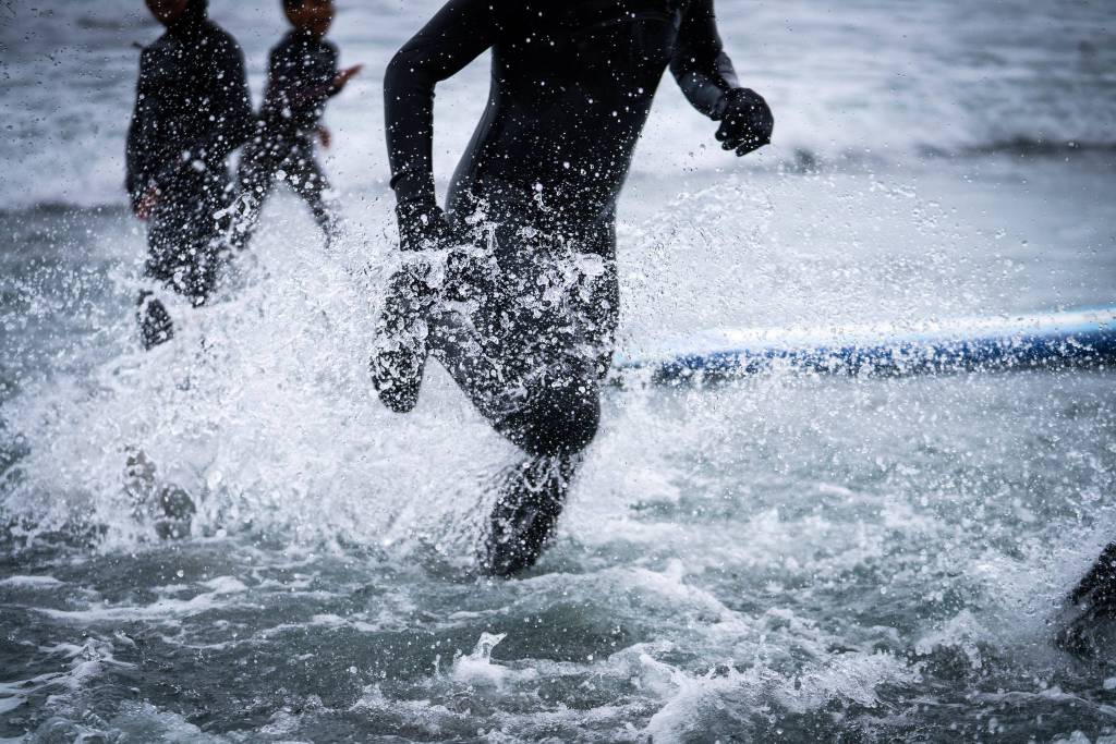 Rain or shine, participants were eager to splash into the waves after several days of instruction and safety classes that were held inside. Courtesy Photo / Bethany Sonsini Goodrich)