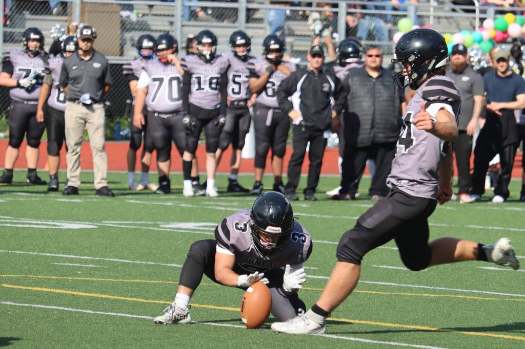 Wallace Adams winds up to put the football through the uprights against Dimond High School. (Ben Hohenstatt / Juneau Empire)