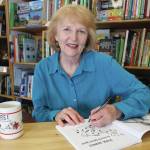 Author Dorothy Dotty Cline signs copies of Paul Banks, Alaskan Music Man at the Homer Bookstore on Sept. 27, 2014, in Homer, Alaska. (Photo by McKibben Jackinsky / Homer News File)
