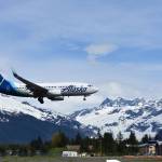 A plane lands at Juneau International Airport on May 25, 2021, as the number of travelers in the state started to rise after the lockdowns of 2020. Travel numbers are not back up to their pre-pandemic levels, but they are increasing according to local travel authorities. (Peter Segall / Juneau Empire file)