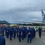 Coast Guardsmen stand in formation at Juneau International Airport as the body of Chief Petty Officer Jeffery DeRonde, who died over the weekend, is loaded on an airplane on Sept. 7, 2021. (Courtesy photo / Capital City Fire/Rescue)