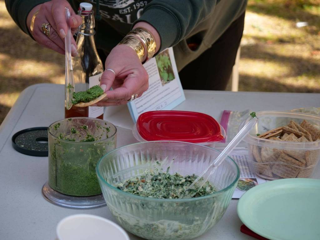 Heather Evoy spreads nettle pesto during a recent plant symposium. (Courtesy Photo / Vivian Mork Yéilk)