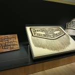 Chilkat robes, and at left, a pattern board used by the artist to weave the crest design. The robe at center, on loan from the Peabody Essex Museum in Salem, Massachusetts, is the earliest and finest known Chilkat robe, according to Steve Henrikson, curator of collections at Alaska State Library, Archives and Museum. The Spirit Wraps Around You: Northern Northwest Coast Native Textiles is on display until Oct. 9. Photos like this and others documenting the exhibit are available in a new book celebrating the end of the exhibit. (Courtesy Photo/ Steve Henrikson, Alaska State Library Archives and Museum)