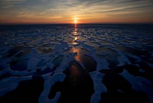 In this July 2017 photo, the midnight sun shines across sea ice along the Northwest Passage in the Canadian Arctic Archipelago. The Biden administration is stepping up its work to figure about what to do about the thawing Arctic, which is warming three times faster than the rest of the world. The White House said Friday, Sept. 24, 2021, that it is reactivating the Arctic Executive Steering Committee, which coordinates domestic regulations and works with other Arctic nations. It also is adding six new members to the U.S. Arctic Research Commission, including two indigenous Alaskans. (AP Photo / David Goldman)