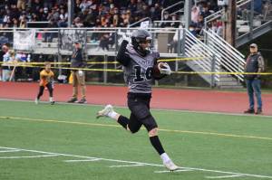 James Connally, a senior, makes his way toward the end zone to open the scoring for the Juneau Huskies. Connally also caught a pair of touchdowns in a 42-7 win against South Anchorage High School. (Ben Hohenstatt / Juneau Empire)