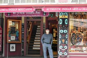 A man stands in the doorway of a downtown shop on Tuesday, July 21, 2020, the day after the City and Borough of Juneau passed an ordinance requiring masks in public places. When passed, the rules included a $25 fine for non-compliance. This week, assembly members reinstated the fine, after they had voted to drop it earlier this summer. (Peter Segall/Juneau Empire File)