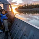 Michael Williams scans the shoreline for moose while traveling up the Yukon River on Tuesday, Sept. 14, 2021, near Stevens Village, Alaska. For the first time in memory, both king and chum salmon have dwindled to almost nothing and the state has banned salmon fishing on the Yukon. The remote communities that dot the river and live off its bounty are desperate and doubling down on moose and caribou hunts in the waning days of fall. (AP Photo/Nathan Howard)