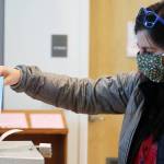 Sarah Traiger drops off a ballot at the Mendenhall Valley Public Library vote center on Tuesday, the last day to cast a ballot in the City and Borough of Juneaus 2021 municipal election. (Ben Hohenstatt / Juneau Empire)
