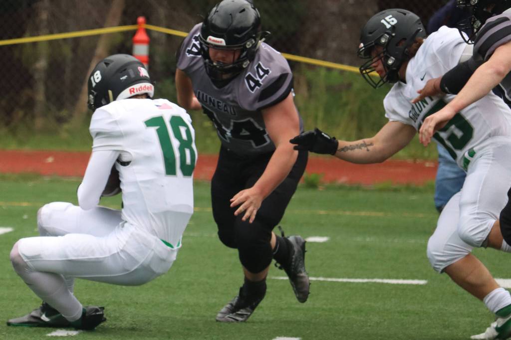 Hunter Derr prepares to wrap up the Colony High School quarterback. (Ben Hohenstatt / Juneau Empire)