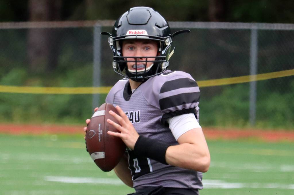 Quarterback Noah Chambers, a senior, prepares to throw during a Week 1 win against Colony. (Ben Hohenstatt / Juneau Empire)