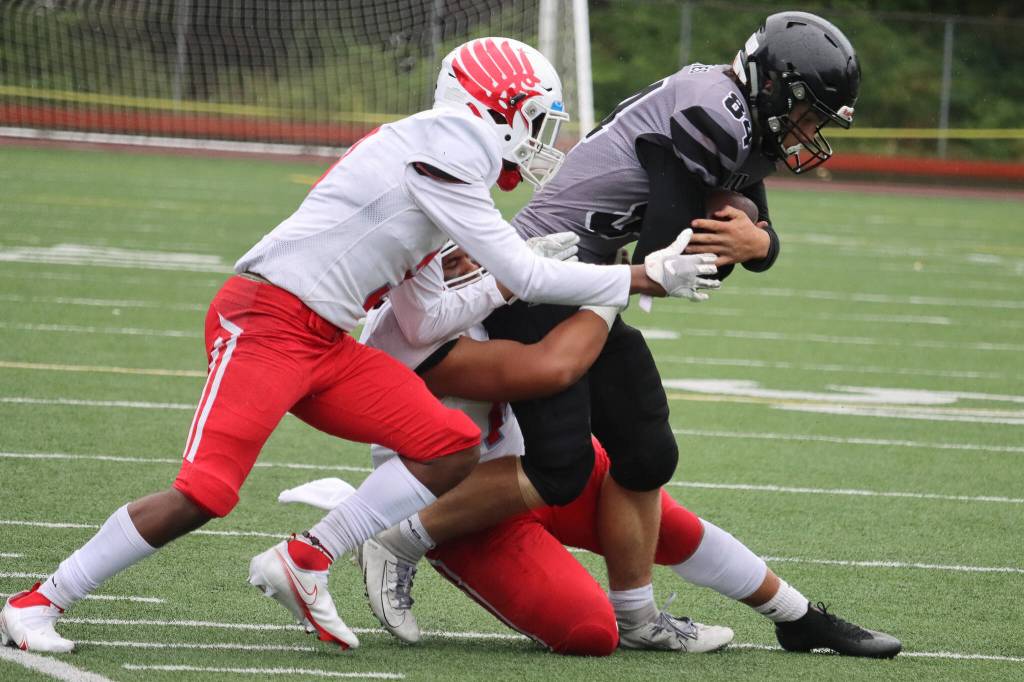 Wallace Adams, a senior defensive back, tight end and kicker, plows ahead against East Anchorage. Adams earned all-conference honors on both sides of the ball and was named the all-conference kicker, too.