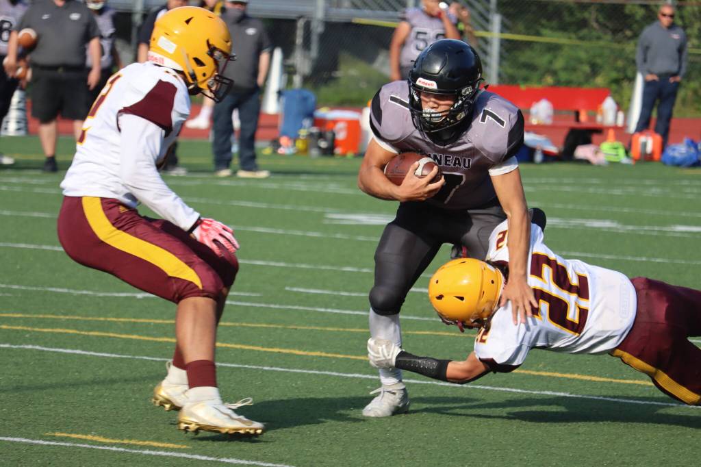 Jamal Johnson, a junior running back, moves through contact during Juneaus first match-up with Dimond High School. The Huskies face Dimond again in the first round of the playoffs. (Ben Hohenstatt / Juneau Empire)