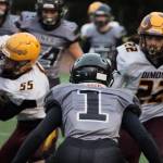 Jarrell Williams, a junior defensive back, prepares to tackle Roman Smith. (Ben Hohenstatt / Juneau Empire)