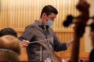 Alan Young leads the Juneau Symphony through a Tuesday night rehearsal inside St. Paul's Catholic Church. (Ben Hohenstatt / Juneau Empire)