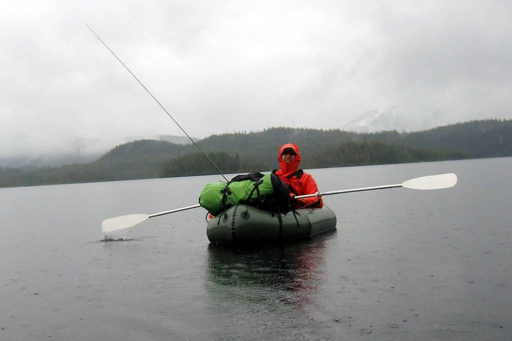 Chris Sergeant paddles in the rain while on the Cross-Admiralty canoe route trip that inspired the study. (Courtesy Photo / Bill Johnson)