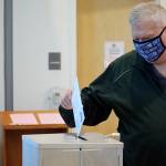 School board member Emil Mackey places a ballot in the drop box at the Mendenhall Valley Public Library vote center on Oct. 5. Three open seats on the Juneau School District Board of Education attracted eight candidates, including two write-in candidates. Based on the most recent election returns, write-in candidate Will Muldoon earned enough votes to win a seat on the board. (Ben Hohenstatt / Juneau Empire)