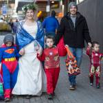 Michelle Ward and Anthony Davidson walk their children, Kyesin, 6, left, CJ, 5, center, and Callen, 2, down Seward Street as they visit downtown merchants for Halloween 2018. This year, downtown businesses are  taking a pass on trick-or-treating. However, options for spooky fun and treat gathering abound. (Michael Penn / Juneau Empire File)