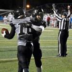 James Connally (10), a senior, and Payton Grant, a junior, embrace following a touchdown. Connally caught and threw for a touchdown in the Huskies 30-17 loss to Bettye Davis East Anchorage High School. (Courtesy Photo / Larry Schrader)