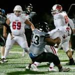 Sam Sika, a junior, takes down the East Anchorage ball carrier on Friday, Oct. 22 during the Division I state championship game played at Service High School in Anchorage. (Courtesy Photo / Larry Schrader)