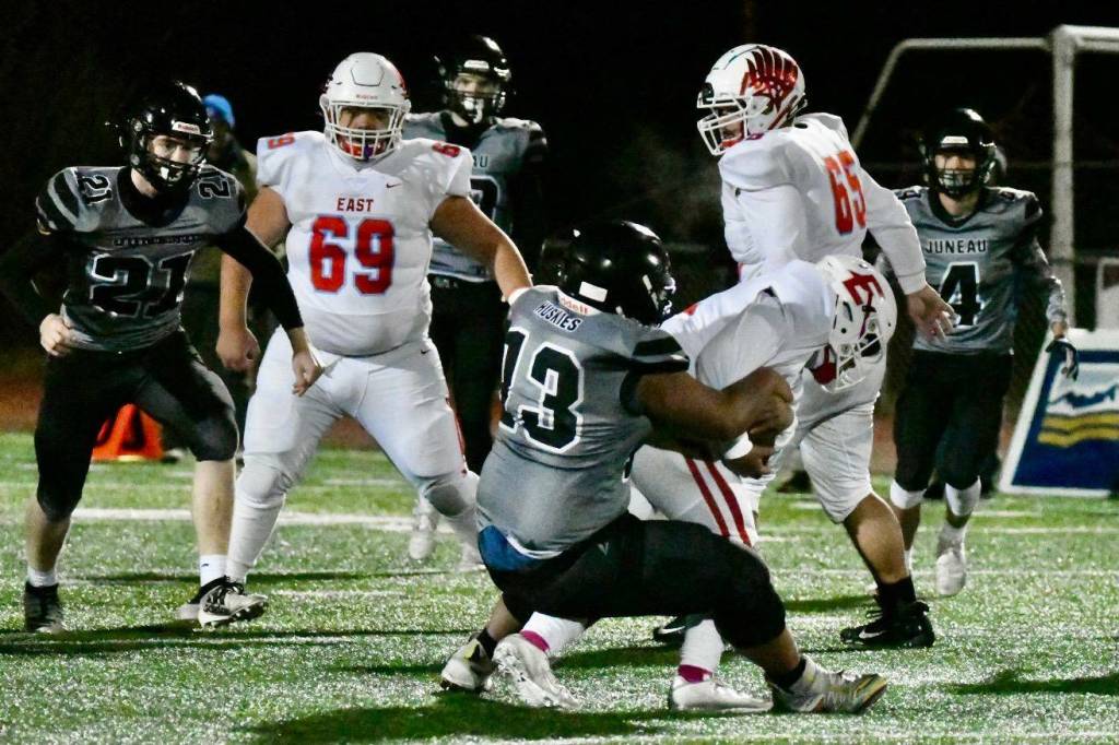 Sam Sika, a junior, takes down the East Anchorage ball carrier on Friday, Oct. 22 during the Division I state championship game played at Service High School in Anchorage. (Courtesy Photo / Larry Schrader)