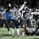Huskies signal that theyve got the ball as Lucas White (21), a junior, recovers a fumble. (Courtesy Photo / Larry Schrader)