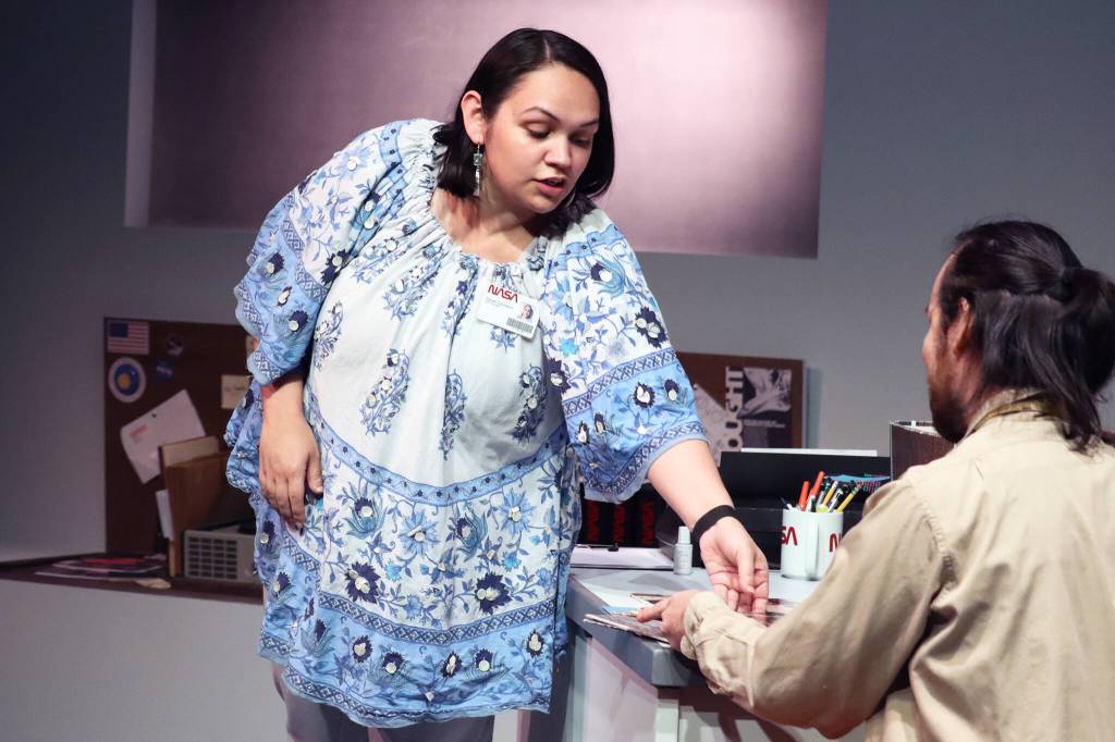 Sarah (Erin Tripp) slides a record to Carl (Jared Olin) while the two low-level NASA workers work to make the 1970s Voyager project happen in a dress rehearsal for Perseverance Theatres Voyager One. (Ben Hohenstatt / Juneau Empire)