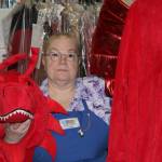 Self-described costume enthusiast and owner of Balloons by Night Moods, Kathy Buell, displays a dragon costume on Oct. 27. She said that the shop offers costumes for men, women and children and that plenty remain available for this weekend's festivities. (Dana Zigmund/Juneau Empire)