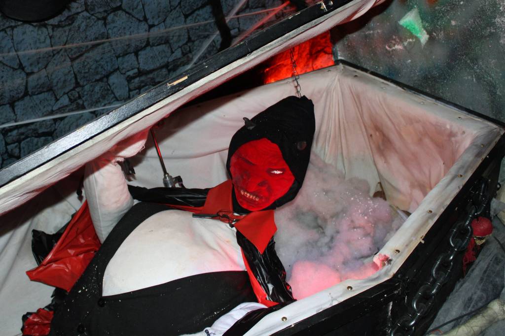 A vampire peeks out of a coffin at Earls Haunted Garage on Oct. 28. Dan Earls, the creator of Earls Haunted Garage, has made about half of the items on display. In addition, he customizes many items that he purchases. This coffin, which opens and closes on its own, was the first Halloween decoration Earls made. (Dana Zigmund/Juneau Empire)