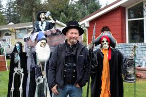 On Oct. 26, Dan Earls stands among some of the ghosts and ghouls that greet people who visit the haunted garage he constructs at his home each year. Earls, who lives at 9420 Berners Ave., welcomes hundreds of people a season through his display, which winds through his garage and spreads onto a neighbors yard. (Dana Zigmund/Juneau Empire)