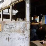Roger Topp of the UA Museum of the North captures images inside the former Fairbanks city bus that gained fame as the final resting place of Christopher McCandless. (Courtesy Photo / Ned Rozell)