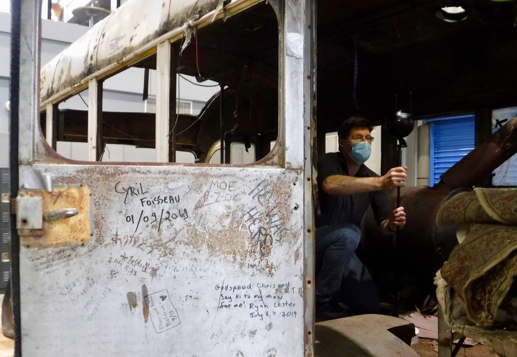 Roger Topp of the UA Museum of the North captures images inside the former Fairbanks city bus that gained fame as the final resting place of Christopher McCandless. (Courtesy Photo / Ned Rozell)