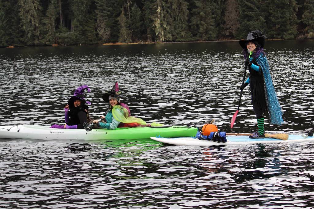 Marisol Elizarraras, left, Kira Shollenberger, center, and Bev OBrien, right, take part in the first Witches Paddle on Auke Lake on Saturday, Oct. 30. (Dana Zigmund/Juneau Empire)
