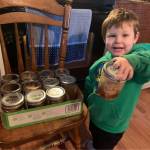 Grandson Bear James Hurst receives his familys case of smoked coho. (Courtesy Photo / Nikka Mork)