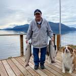 Oscar and Kéet inspect the fresh cohos caught by Mickey Prescott. (Vivian Faith Prescott / For the Capital City Weekly)
