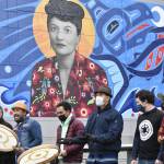 Peter Segall / Juneau Empire 
Artists of the inaugural Rock Aakw Indigenous Music Festival gather beneath the mural of Elizabeth Peratrovich on the Juneau waterfront on Friday, Nov. 5, 2021. This year the ceremony was all virtual, but organizers wanted to open the festival in person.