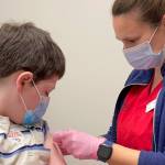 In this Wednesday, Nov. 3, 2021, photo provided by Primary Health Medical Group, Ben Weiss, 10, gets a COVID-19 vaccine at Primary Health Medical Group in Meridian, Idaho. (Tracy Morris/Primary Health Medical Group via AP)