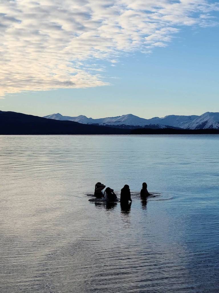 This photo shows a cold dip healing practice in North Douglas. Participants are Jennifer Quinto, Margarte Haube, Sarah Haube, and Jamiann Seiltin Hasselquist. (Courtesy Photo / Michele Peterson-Isaak)