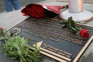Flowers lay at the plaque of Juneaus 9/11 memorial on Sept. 11, 2006. The memorial, located in Riverside Rotary Park in the Mendenhall Valley was the first in the nation. Twenty years ago, Juneau resident Debbie Penrose-Fischer and her husband Brent Fischer harnessed their grief in the face of the national tragedy to become the driving force behind the creation of the memorial, which serves as a gathering point each Sept. 11 and provides a place for community members to reflect on Veterans Day. (Michael Penn/Juneau Empire File)