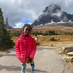 In this photo provided by Ben Pascal, five-year-old Naomi Pascal, holding her teddy bear, is pictured on a hike to Hidden Lake in Glacier National Park, Mont., in October 2020. Naomi lost the bear while on the hike, but it was found by a park ranger who took care of the bear until it was spotted on the dash of his ranger truck and returned to Naomi this fall. (Ben Pascal)