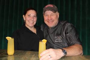 Dana Zigmund / Juneau Empire 
Chef Michael MB Brewer and his wife, Jennry, share a toast Saturday to their new adventures at Roma Bistro on the Wharf. The couple recently moved to Juneau to take on leadership roles at the Juneau Waterfront Restaurant Group, which includes Roma, The Hangar at the Wharf, The Alaska Fish and Chips Company, Pier 49, and Twisted Fish Company Alaska Grill.