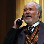 Arthur Birling (Dan Wayne) answers a phone call delivering unwelcome news during a dress rehearsal for Theatre in the Roughs upcoming An Inspector Calls. (Ben Hohenstatt / Juneau Empire)