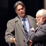 Inspector Goole (Aaron Elmore) shows a photo of Eva Smith to a wincing Arthur Birling (Dan Wayne). Exactly why Birling reacts so poorly is revealed in An Inspector Calls. (Ben Hohenstatt / Juneau Empire)