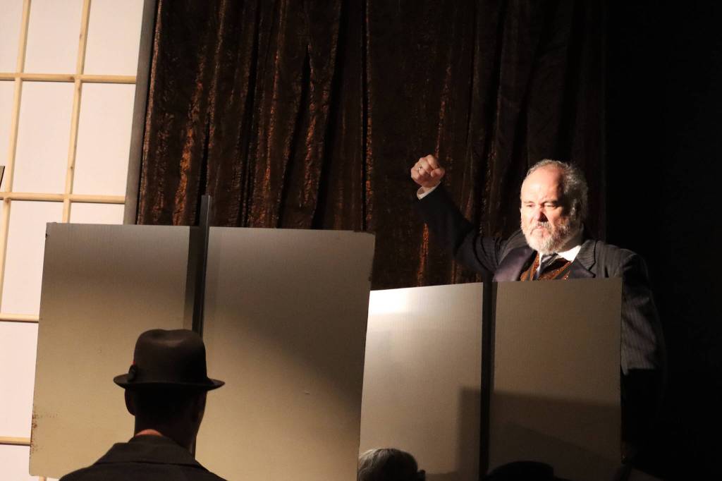 Arthur Birling (Dan Wayne) shakes his fist at sign-holding demonstrators during a dress rehearsal for Theatre in the Roughs upcoming An Inspector Calls. The play was written in the 1940s by J.B. Priestley, a notable British socialist, broadcaster and writer. Labor politics are more subtext than overt in An Inspector Calls but the affiliation with socialism did not help the plays popularity in the U.S. in the late 40s and 50s. (Ben Hohenstatt / Juneau Empire)