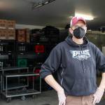 Chris Shapp, executive director of the Southeast Alaska Food Bank, stands outside the food bank on Feb. 18, 2021 as a van full of food donations arrives. Schapp hopes more donations are in store for Saturday as the food bank holds its annual drive. (Michael S. Lockett / Juneau Empire File)