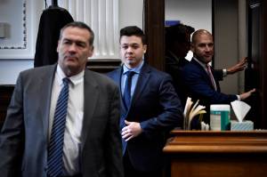 Kyle Rittenhouse, center, enters the courtroom with his attorneys Mark Richards, left, and Corey Chirafisi for a meeting called by Judge Bruce Schroeder at the Kenosha County Courthouse in Kenosha, Wis., on Thursday, Nov. 18, 2021. (Sean Krajacic / The Kenosha News)
