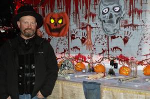 Dan Earls shows off some of the scenes on display at Earls' Haunted Garage. On Oct. 28, he was adding finishing touches to his display in anticipation of thrill-seekers who will stop by for a scare over Halloween weekend. His haunted garage resulted in 1,563 pounds of donated food headed to local food banks. (Dana Zigmund/Juneau Empire)