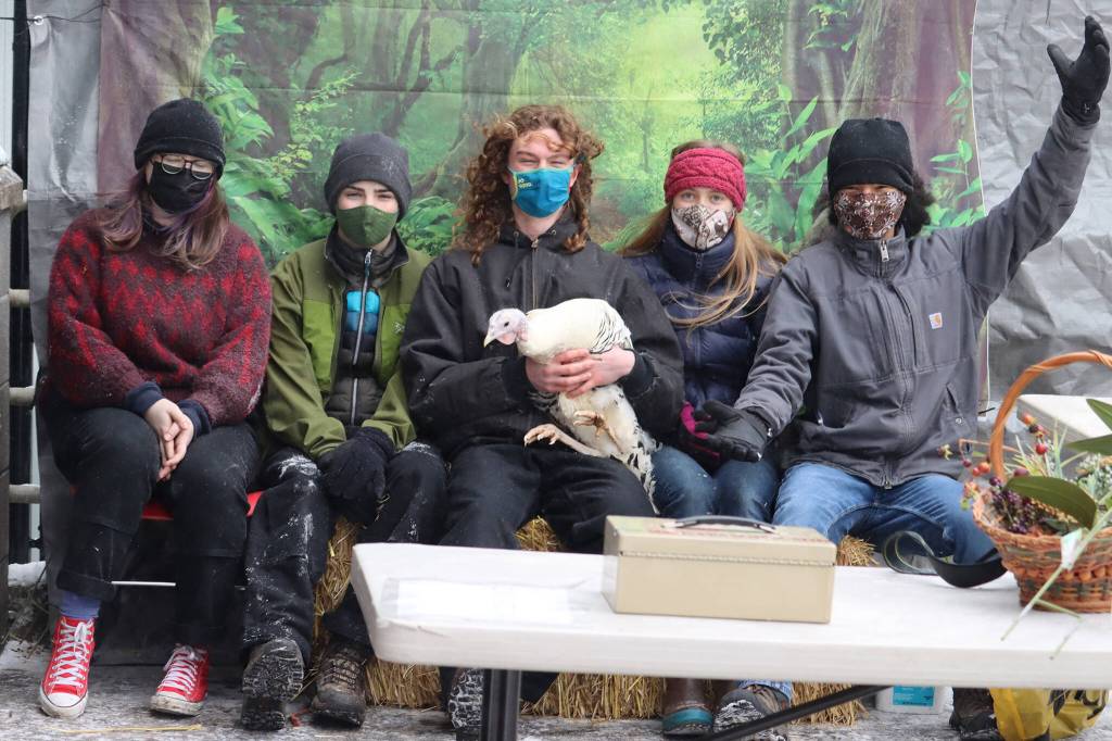 IGNITE Club members Eva Storm, Carson Carrle, Gabe Hansen, Ashlynn King and Trevor Daniels pose with Penny the turkey on Saturday. (Ben Hohenstatt / Juneau Empire)